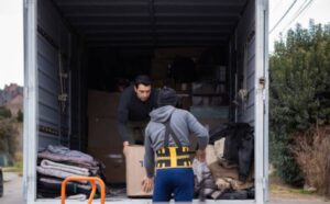 Moving staff loading furniture into a truck during home relocation
