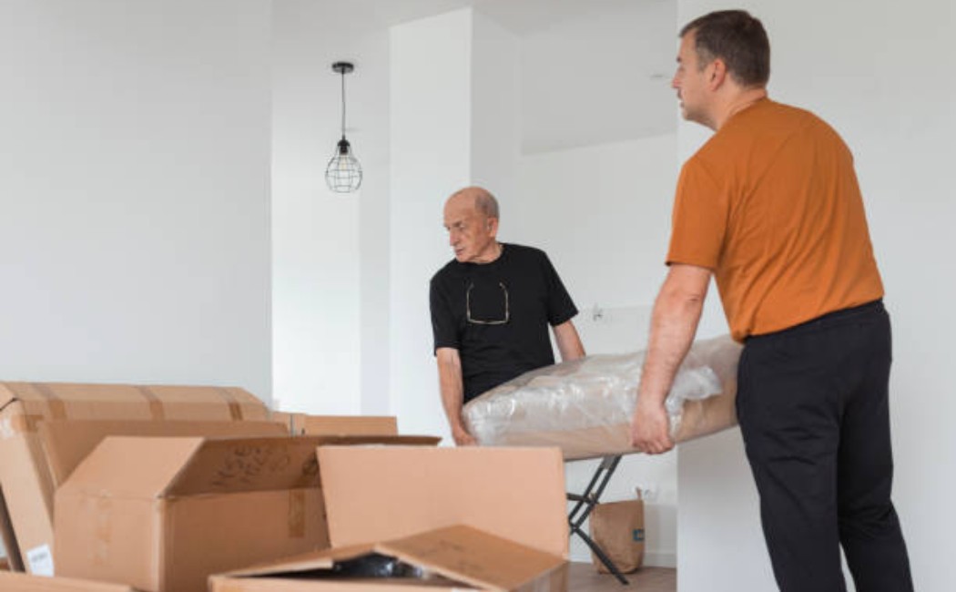 Moving staff loading furniture into a truck during home relocation