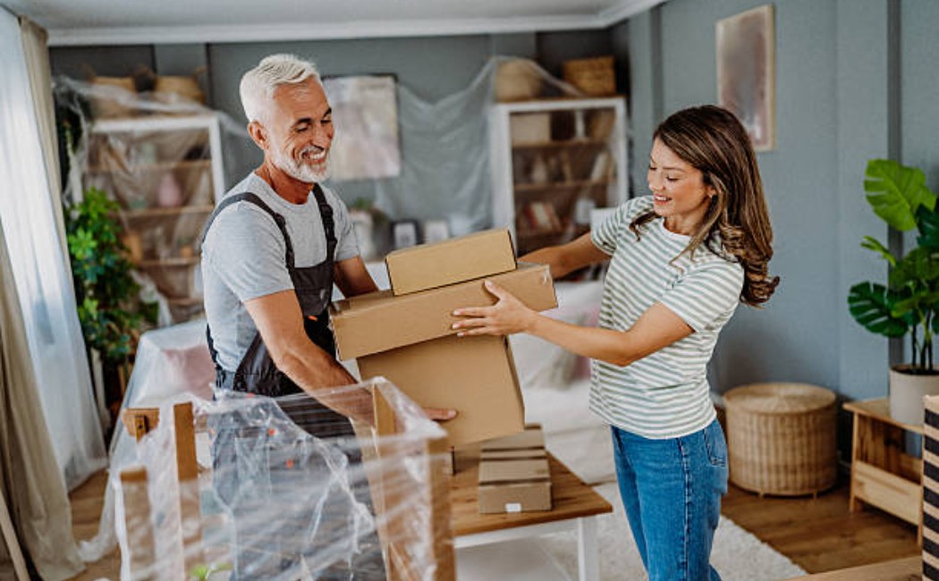 Unpacking services team arranging boxes in a new house