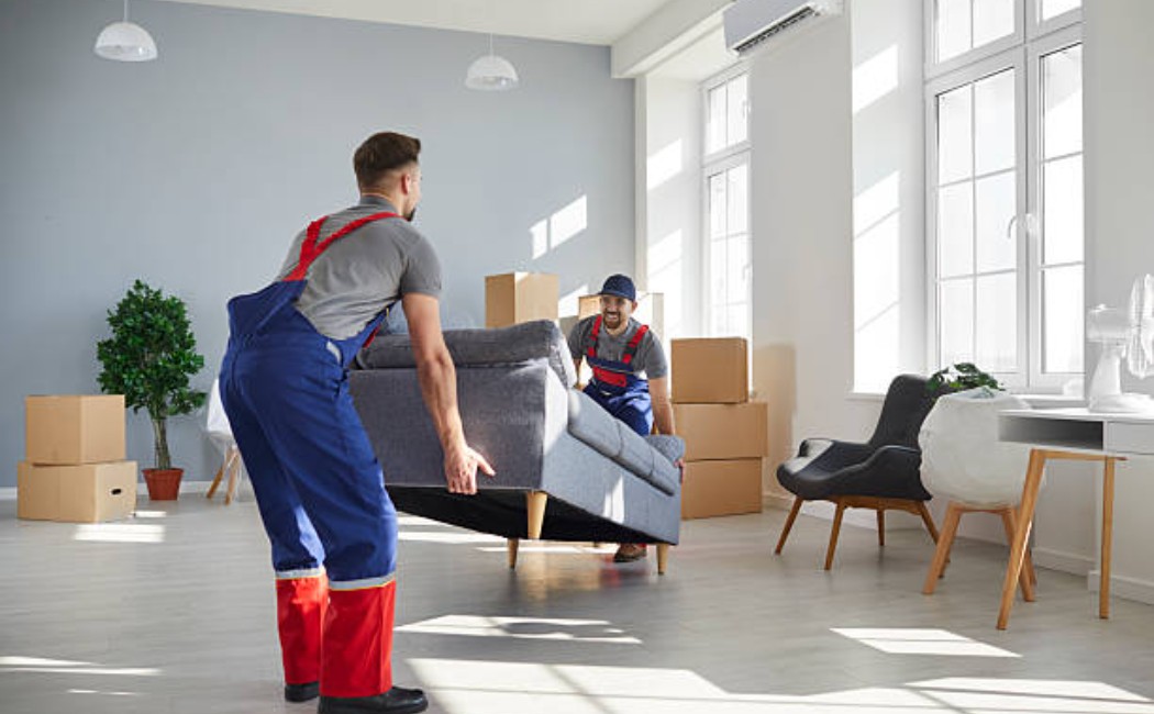 Team lifting a couch during a residential moving process