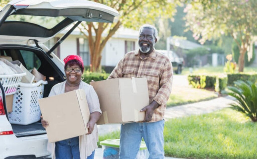 Senior couple unloading moving boxes together