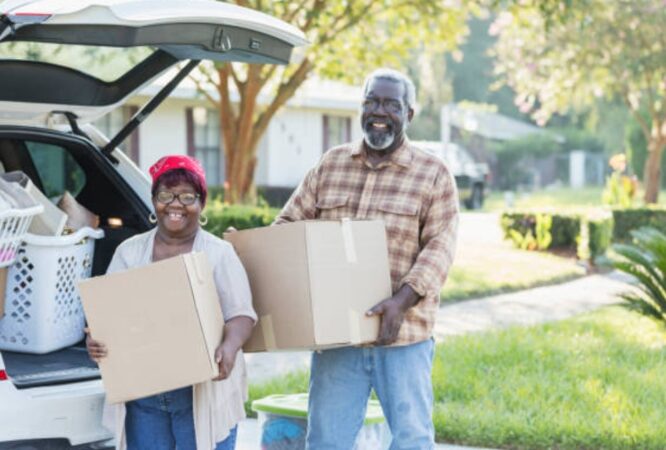 Senior couple unloading moving boxes together