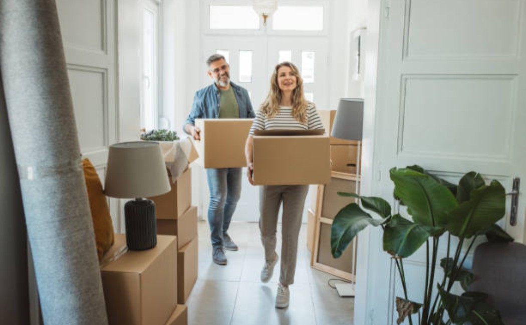 A senior man and woman unpacking boxes in a new house