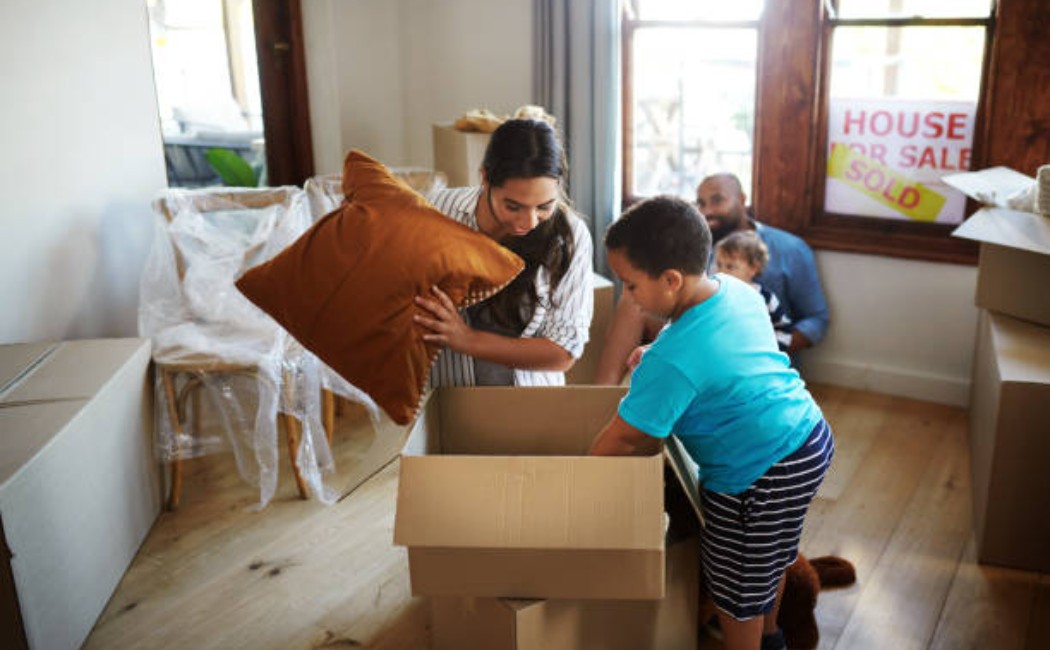 Moving a cardboard box with a heart and a funny quote