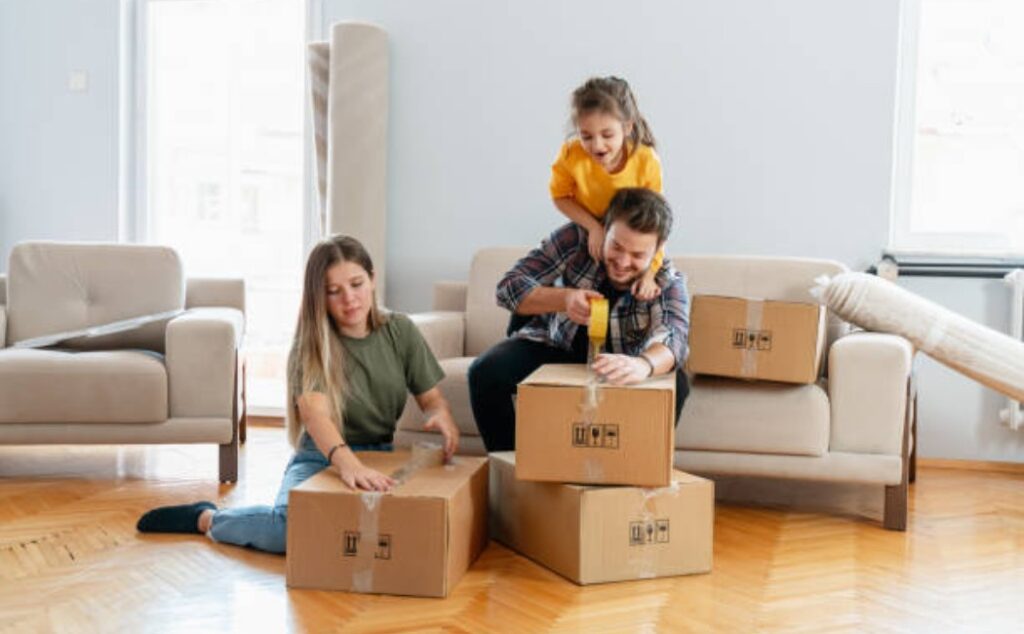 Family unpacking boxes and smiling in the new home