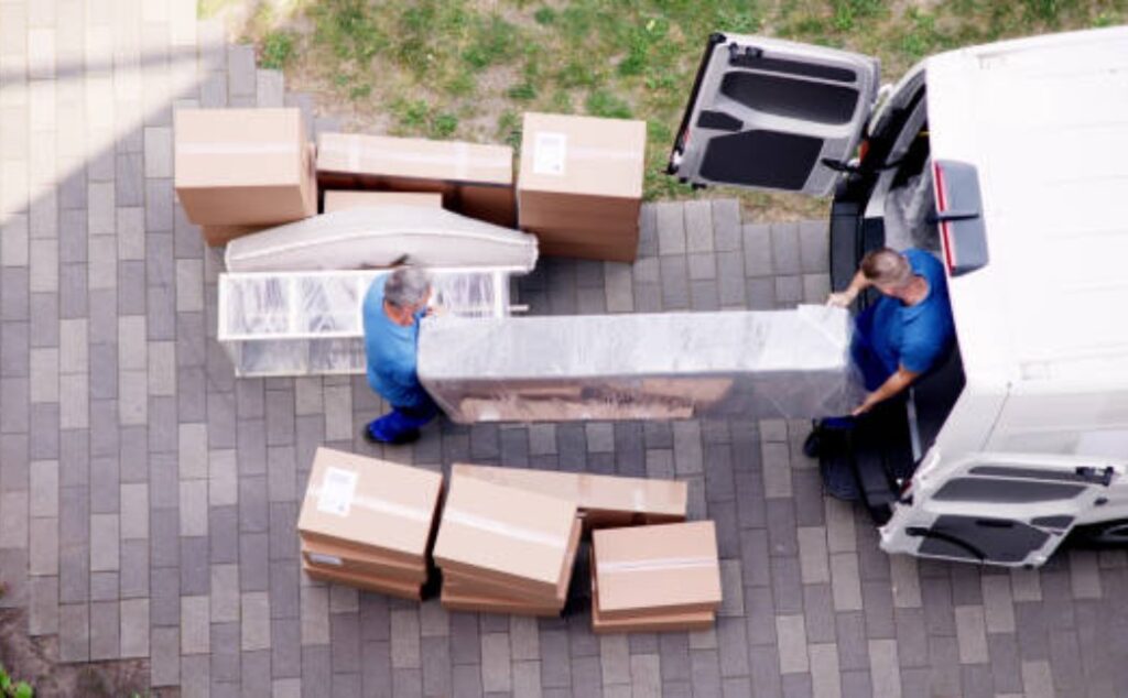 Packing and moving service van with furniture and boxes loaded.