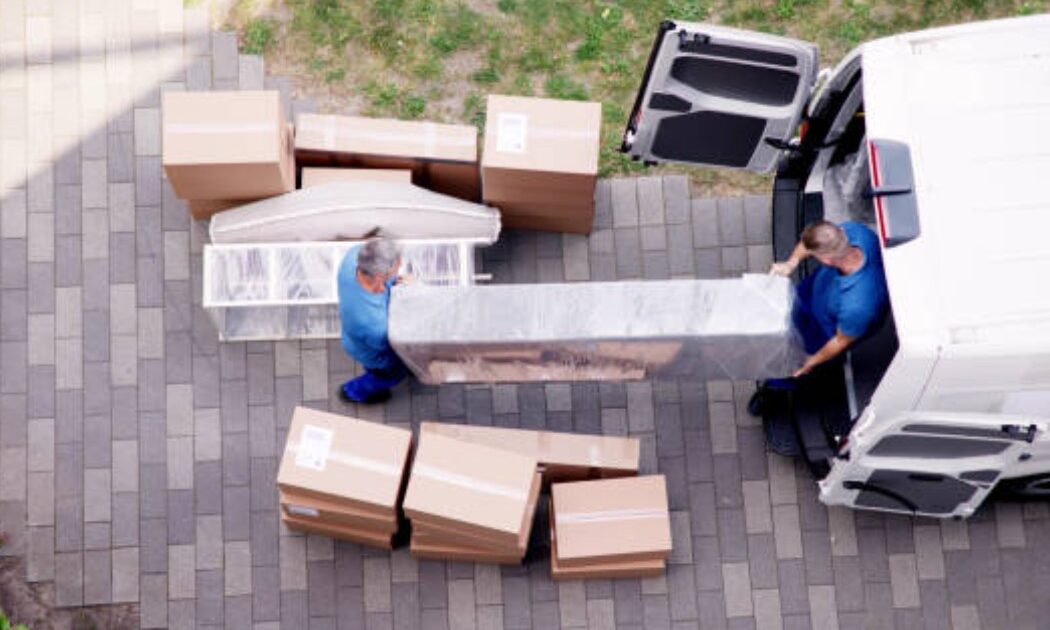 Packing and moving service van with furniture and boxes loaded.