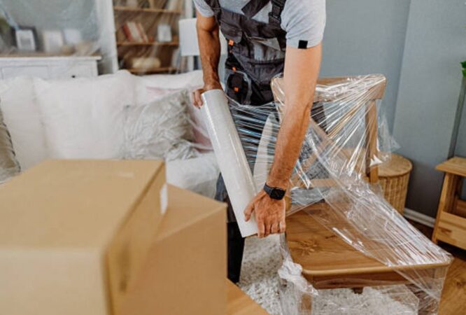 Family Packing boxes into the new home entrance.