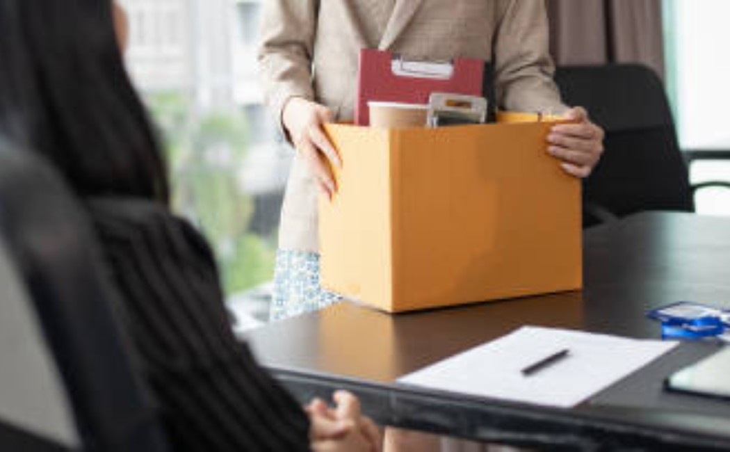 Office worker packing items after resignation.